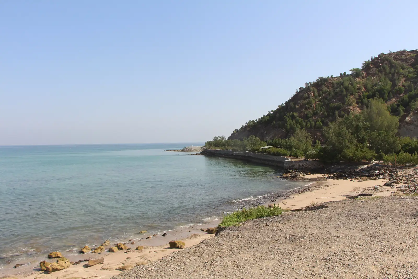 Clear water and a rocky beach on the Dibba Al Fujairah coast, where boats leave for Dibba Rock