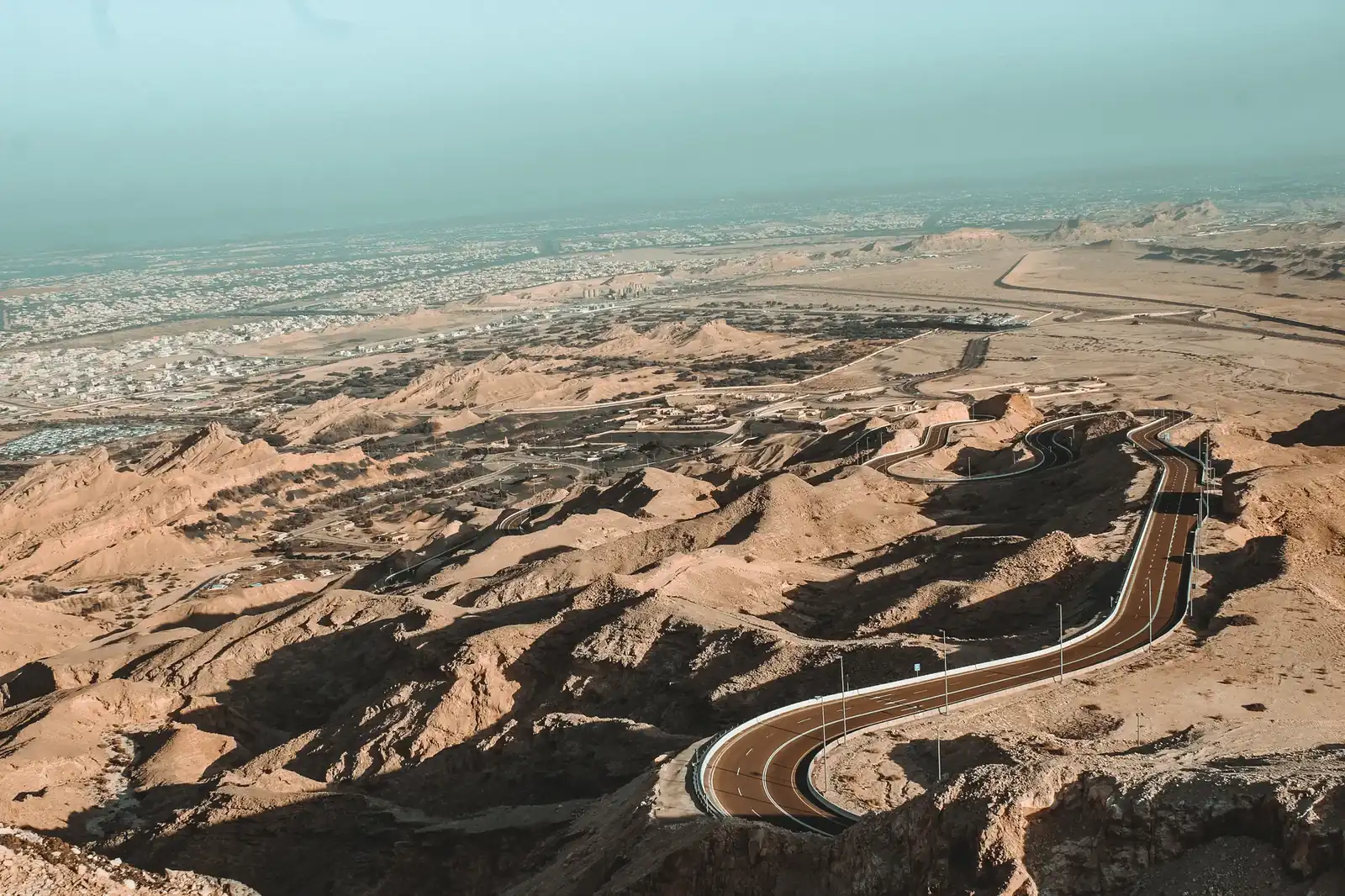 The Jebel Hafeet mountain road winding through bare limestone ridges above Al Ain